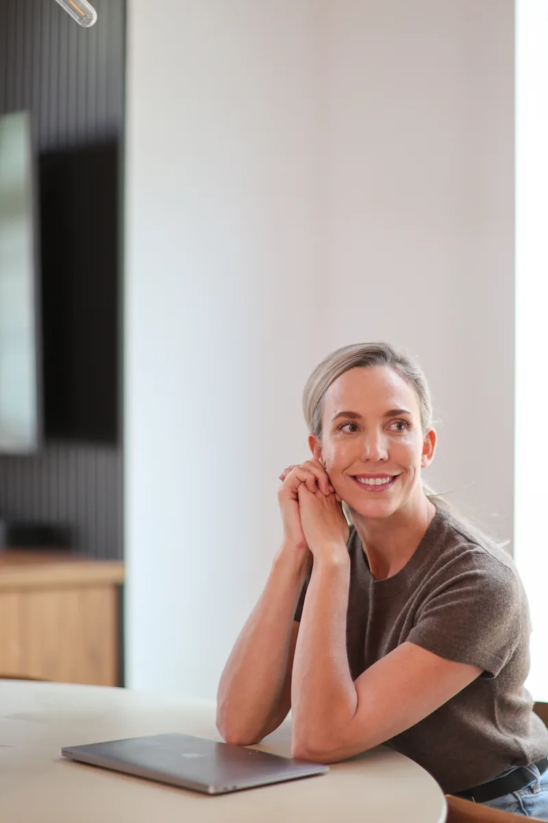 Dr. Marissa Gaucher smiling beside a round table