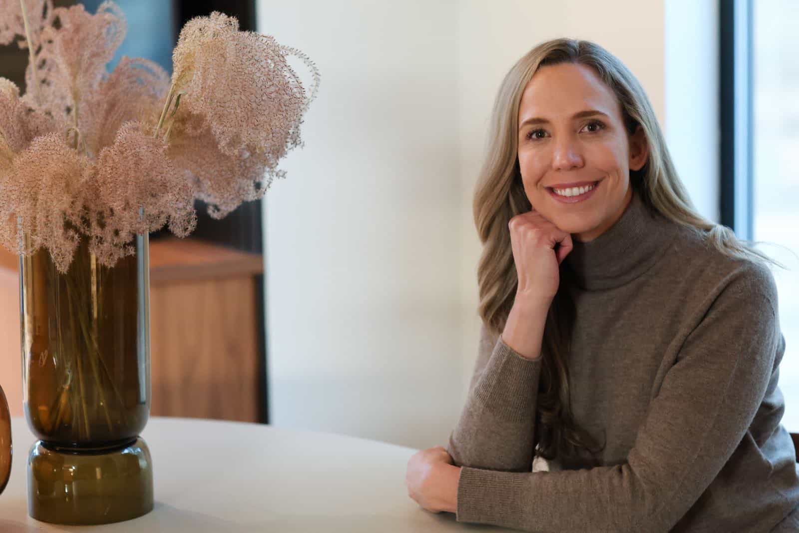 Dr. Marissa Gaucher, ND - Dr. Marissa Gaucher Dr. Marissa Gaucher, Naturopathic Doctor, seated beside flowers in her clinic