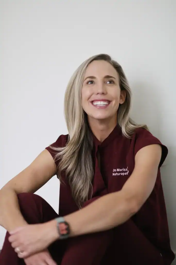 Dr. Marissa Gaucher smiling in burgundy scrubs