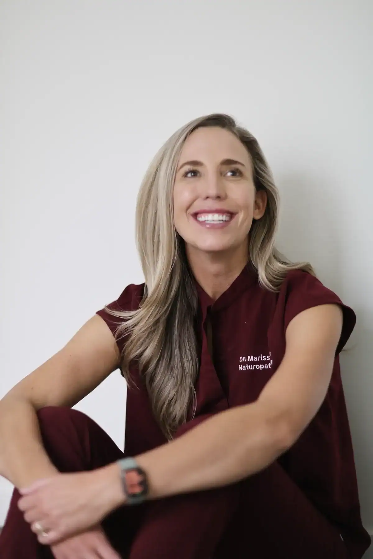 Dr. Marissa Gaucher smiling in burgundy scrubs
