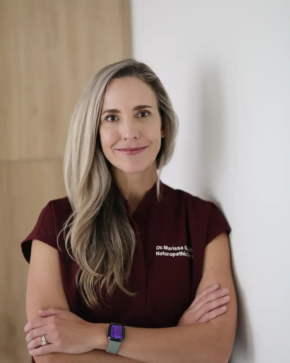 Dr. Marissa Gaucher in clinical scrubs - Dr. Marissa Gaucher Dr. Marissa Gaucher, Naturopathic Physician and cosmetic injector, in burgundy clinical scrubs.